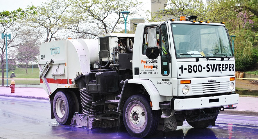 Parking Lot Sweeping Truck Cleaning Purple Dye Off of Road